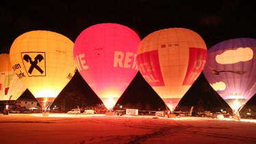 Rows of bulbous luminaries, dozens of feet tall, lit up from the glow of flames: The Night Glow during the Achensee International Balloon Days, © Stephanie Vetter / Achensee Tourismus