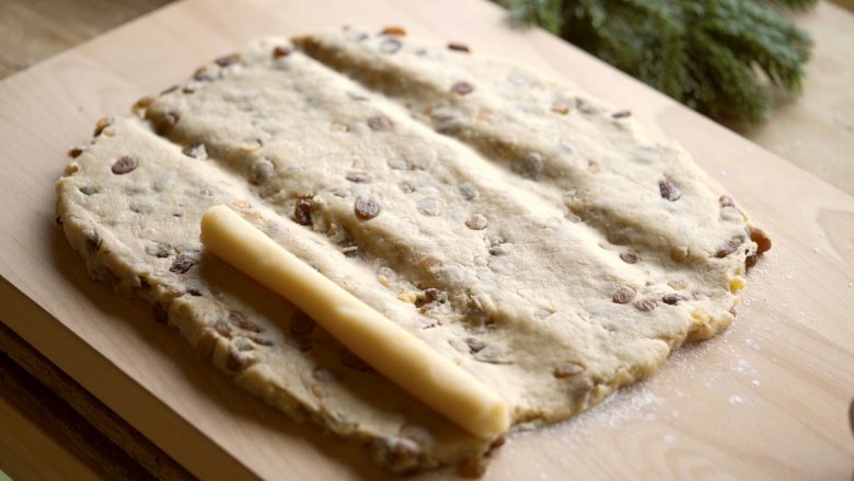 Divide the dough up into thirds and place the marzipan in the left-hand third.