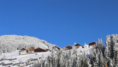 Winterlicher Weiler Rals mit der Jausenstation Mit