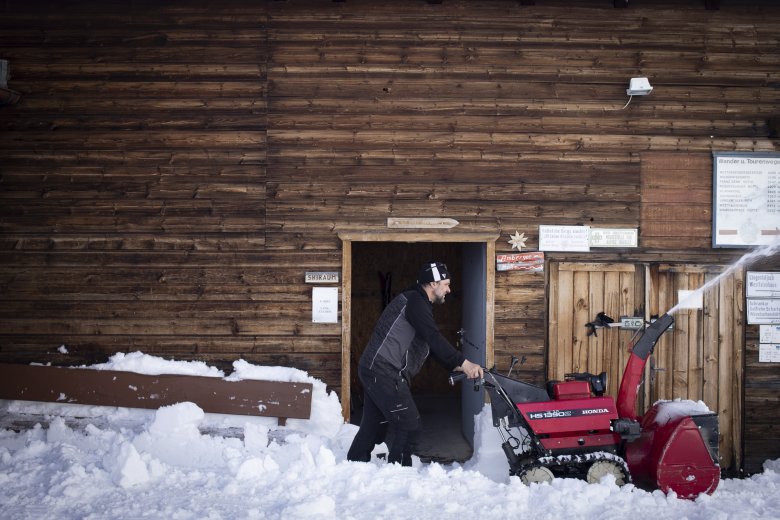 Serafin clears fresh snow from the terrace.
