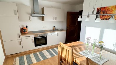 Kitchen with an oven, stove, range hood, refrigerator, freezer, and dishwasher., © Kathrin Huber