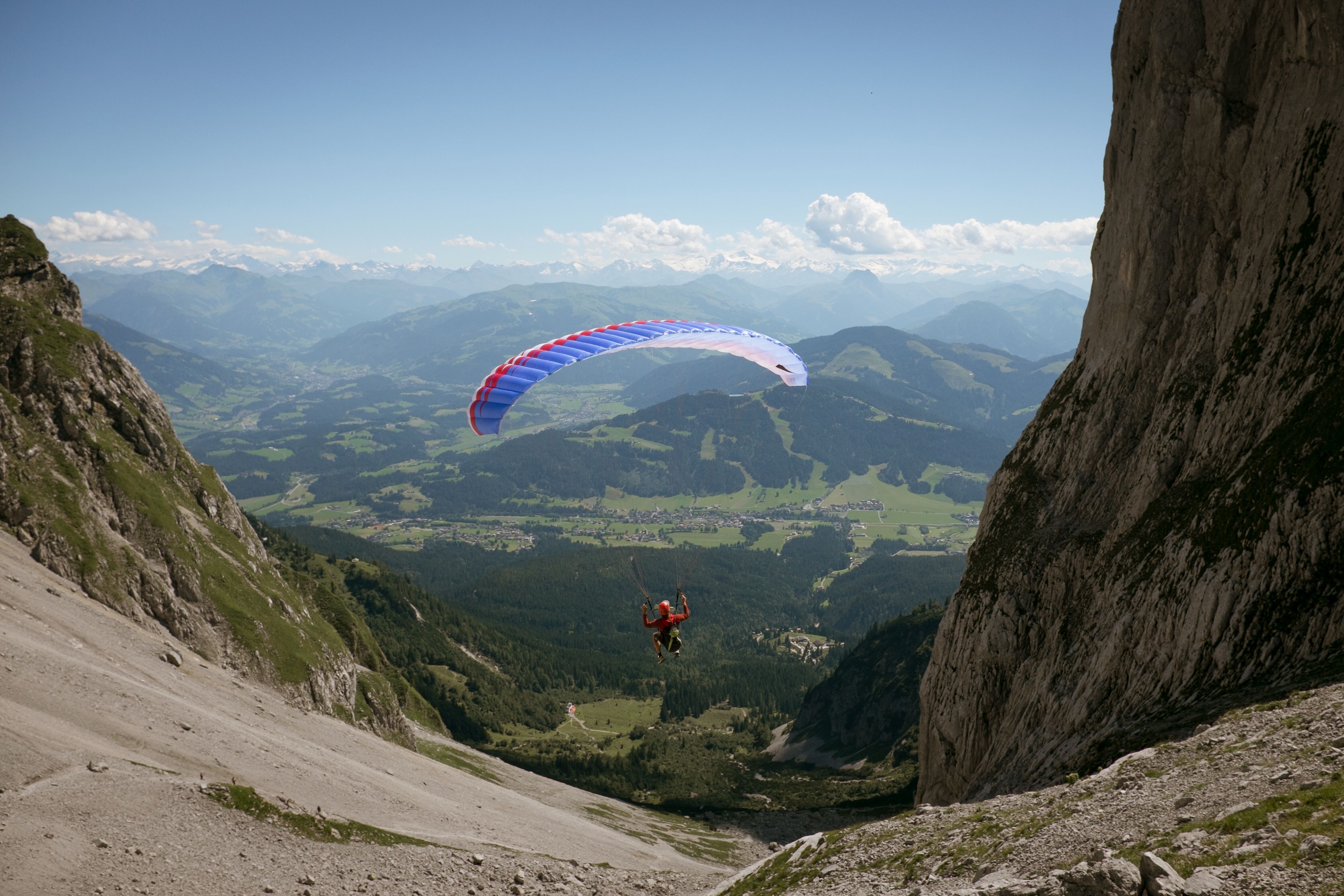 Skydiver is head down flying over a spectacular mountain scenery